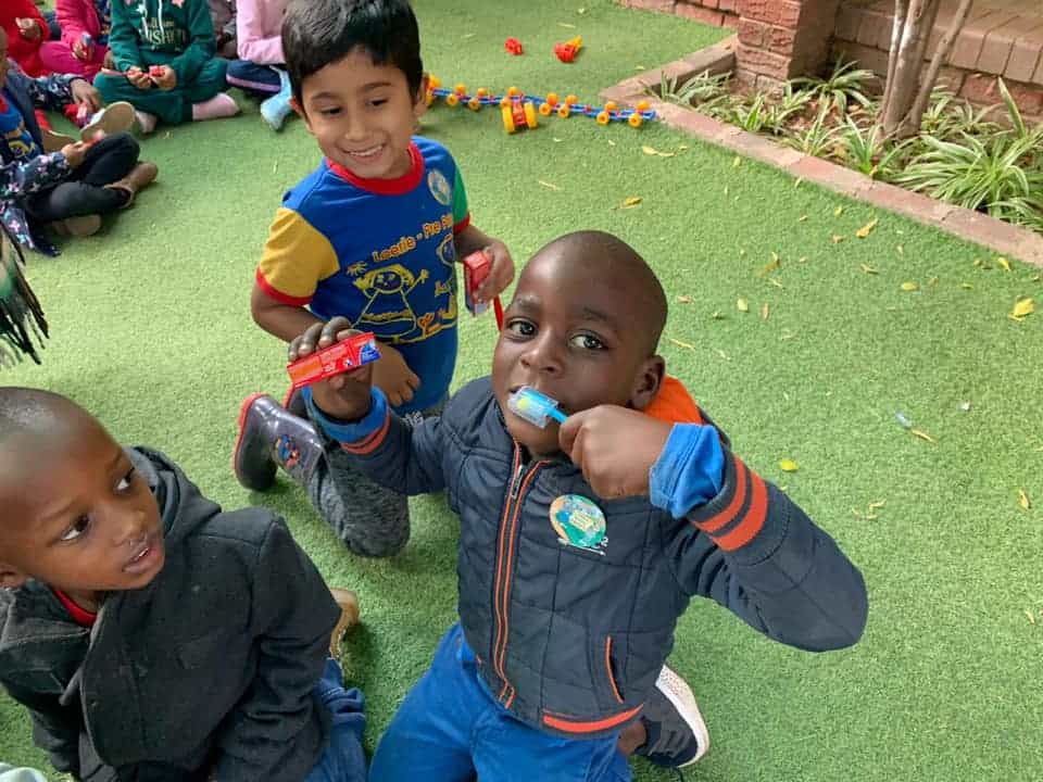 Toothbrush learning activity with children at DrSPateldentist, promoting oral hygiene and children’s dental health.